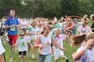 Kids and adults alike are doused with color during the "Color Corridor" Fun Run before the 2012 Color Splash 5K.